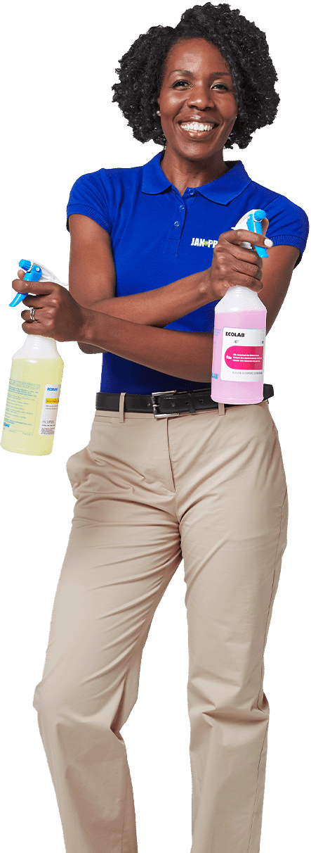 a JAN-PRO Cleaning & Disinfecting employee smiling and holding two spray bottles