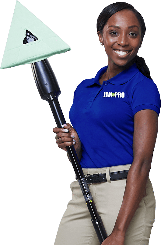 an African-American woman in JAN-PRO Cleaning & Disinfecting attire smiling holding a mop