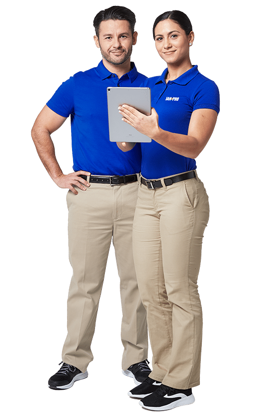 a man and a woman in JAN-PRO Cleaning & Disinfecting attire with the woman holding an Ipad