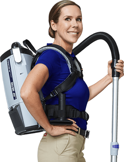 A Caucasian woman JAN-PRO Cleaning & Disinfecting employee posing with cleaning equipment