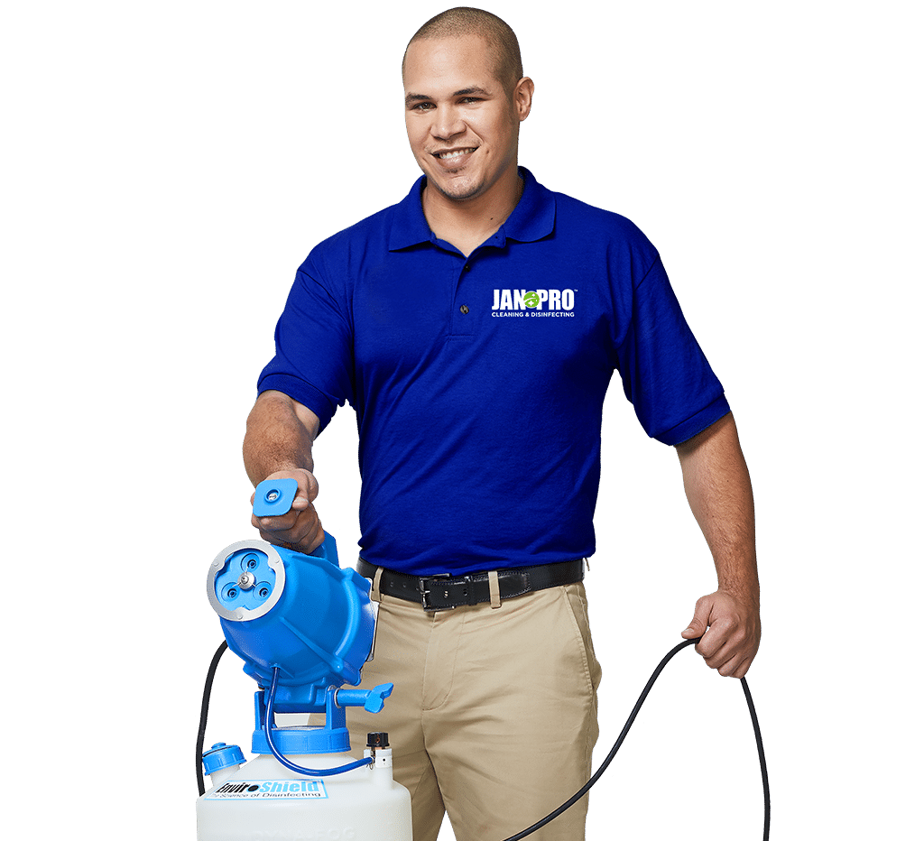 A JAN-PRO Cleaning & Disinfecting employee holding cleaning equipment