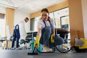 commercial cleaner vacuuming a carpet.