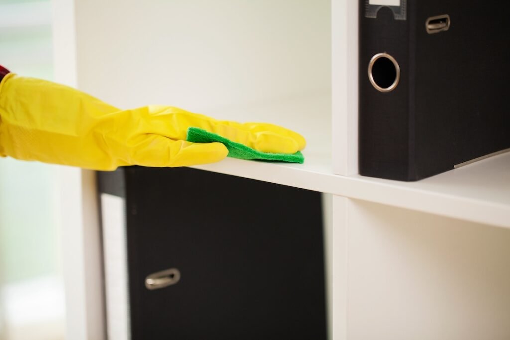 Commercial cleaner cleaning in the office with a wet cloth.