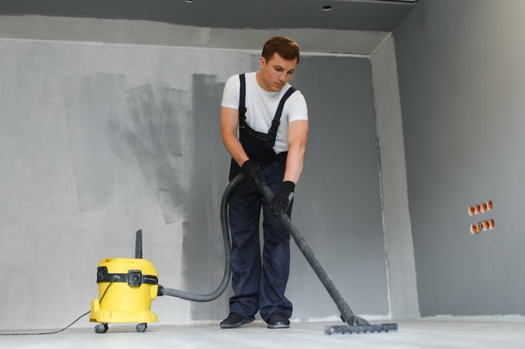 Commercial cleaner vacuum cleaning during apartment renovation.