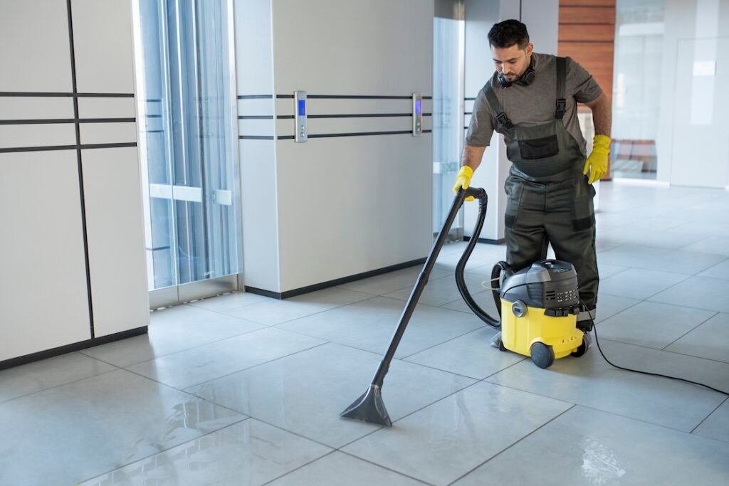 Image of a commercial cleaning professional cleaning tile floors.