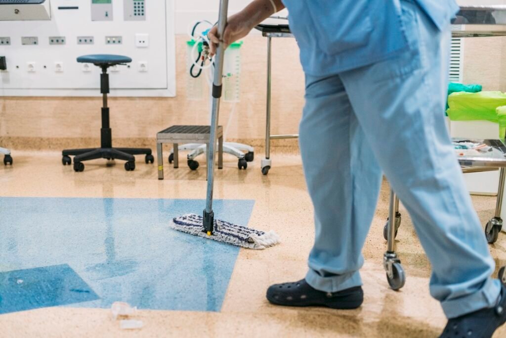 A hospital worker doing cleaning in operation room.
