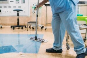 A hospital worker doing cleaning in operation room.