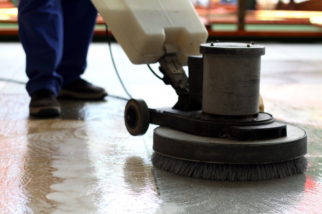 Floor polishing machine cleaning a floor.
