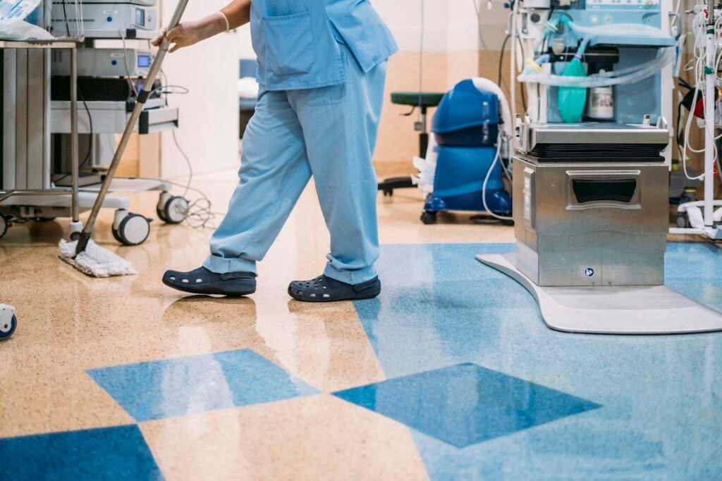 A hospital worker doing cleaning in operation room.
