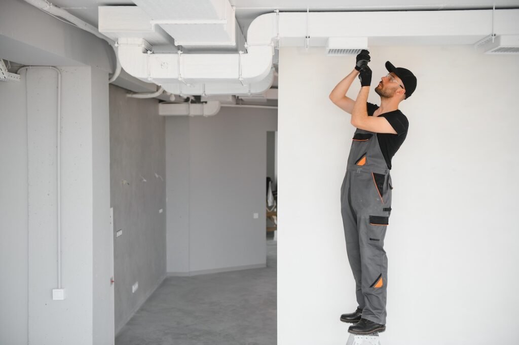 Ventilation cleaning. Specialist at work. Repair ventilation system HVAC.