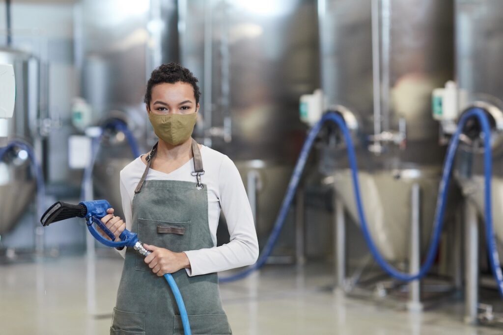 A commercial cleaning professional holding an industrial vacuum.