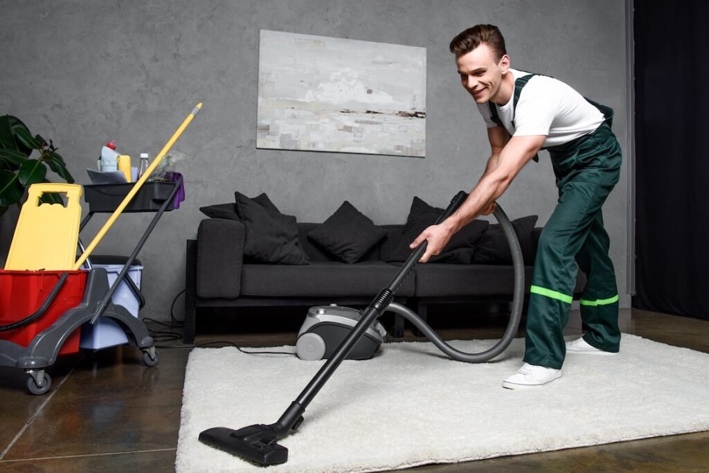 Commercial cleaner vacuuming a rug